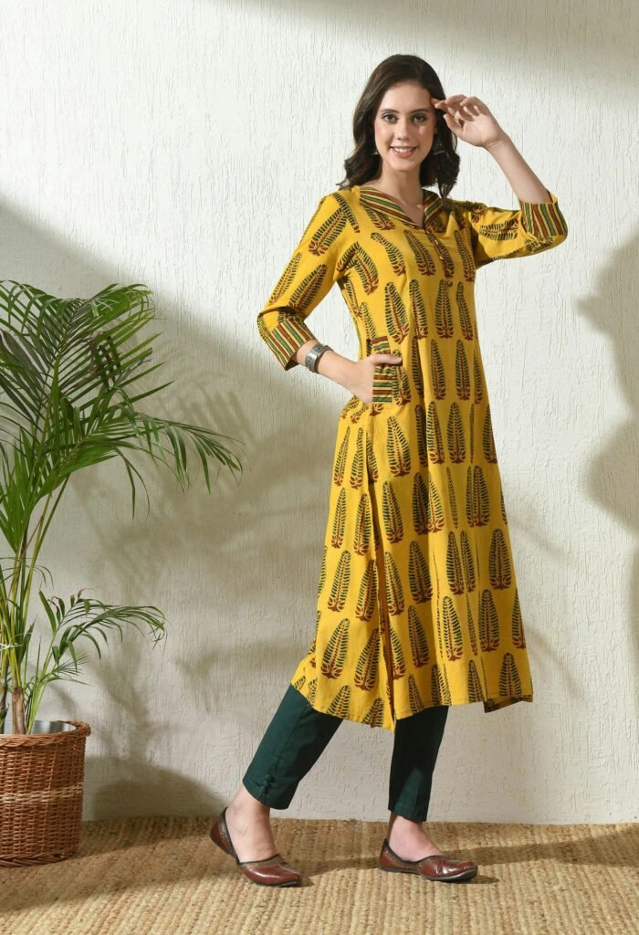 pexels-photo-28213774-28213774 Woman posing in stylish Ajrakh printed kurta, showcasing ethnic fashion indoors.
